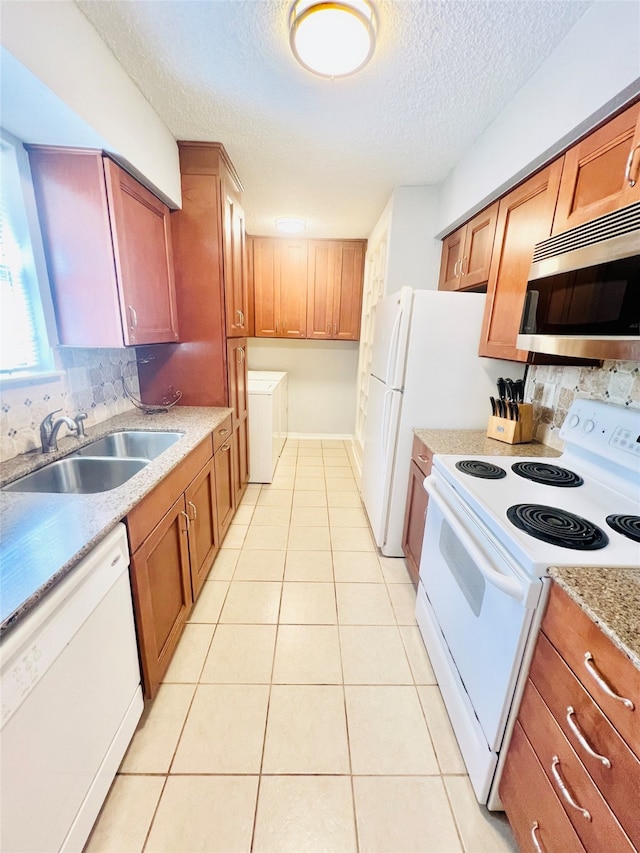 kitchen with sink, decorative backsplash, white appliances, and light tile patterned floors