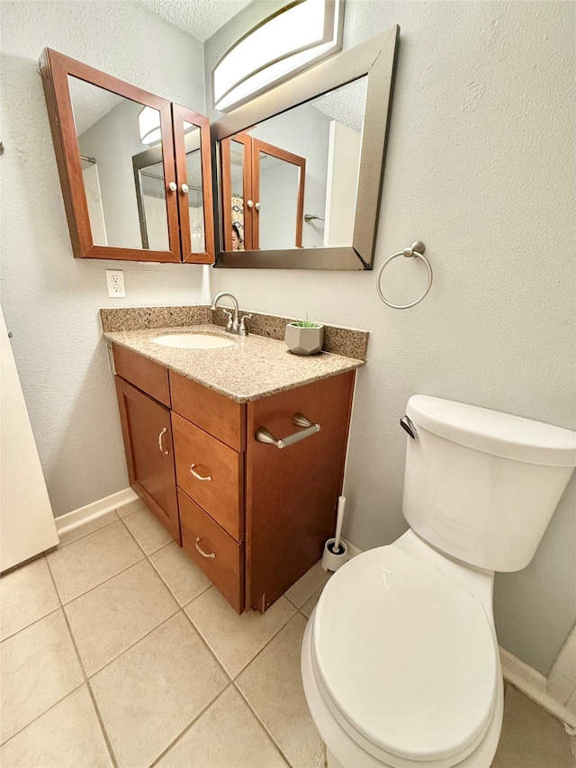 bathroom with vanity, toilet, and tile patterned floors