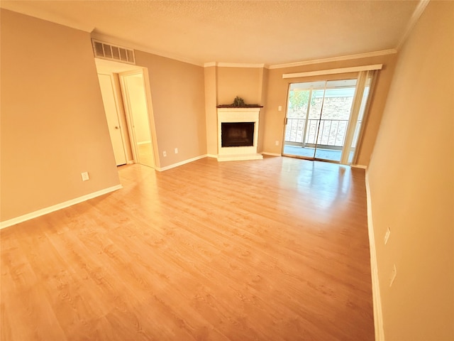 unfurnished living room with crown molding, a textured ceiling, and hardwood / wood-style floors