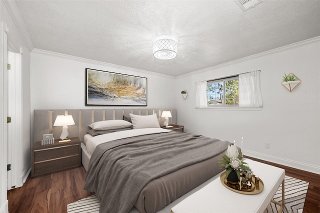 bedroom featuring ornamental molding, baseboards, wood finished floors, and a textured ceiling