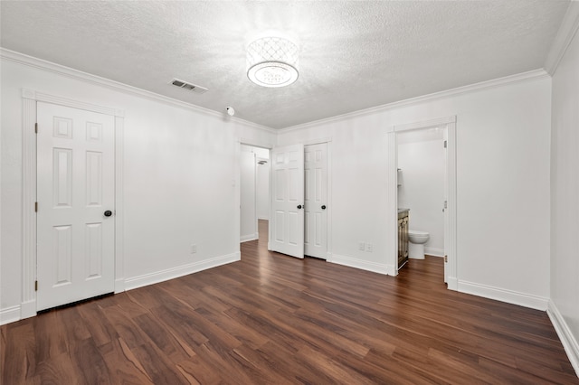 unfurnished bedroom featuring dark hardwood / wood-style floors, connected bathroom, and a textured ceiling