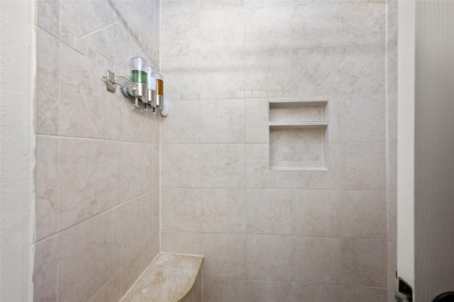 bathroom with a tile shower