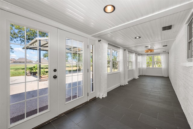 unfurnished sunroom with french doors