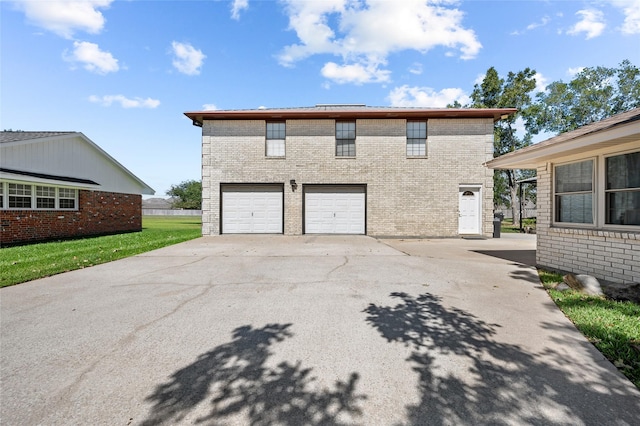 view of side of property with a garage, driveway, and brick siding