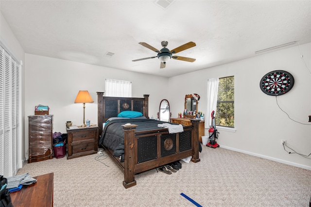 bedroom with ceiling fan and light colored carpet