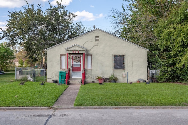 bungalow-style home with a front lawn