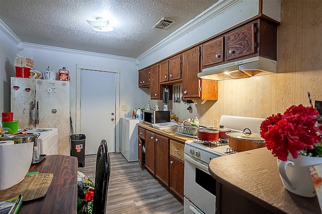 kitchen featuring white appliances, a textured ceiling, washer / dryer, crown molding, and light hardwood / wood-style floors