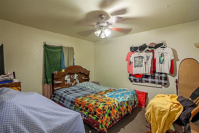 carpeted bedroom featuring a textured ceiling and ceiling fan