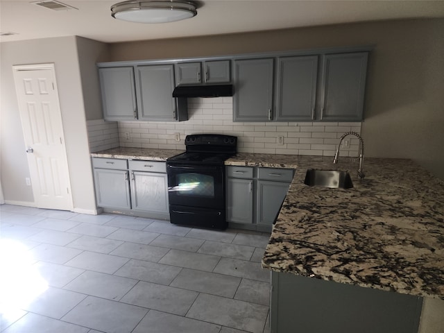 kitchen with sink, black electric range oven, stone countertops, gray cabinets, and backsplash