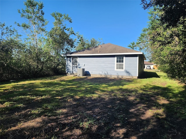 view of home's exterior with central air condition unit and a lawn