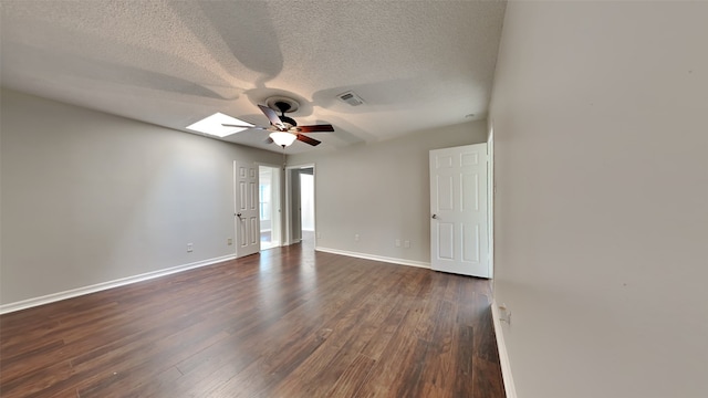 spare room featuring ceiling fan, dark hardwood / wood-style floors, and a textured ceiling