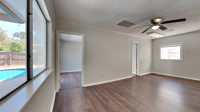 unfurnished room with dark hardwood / wood-style floors, ornamental molding, a textured ceiling, and ceiling fan