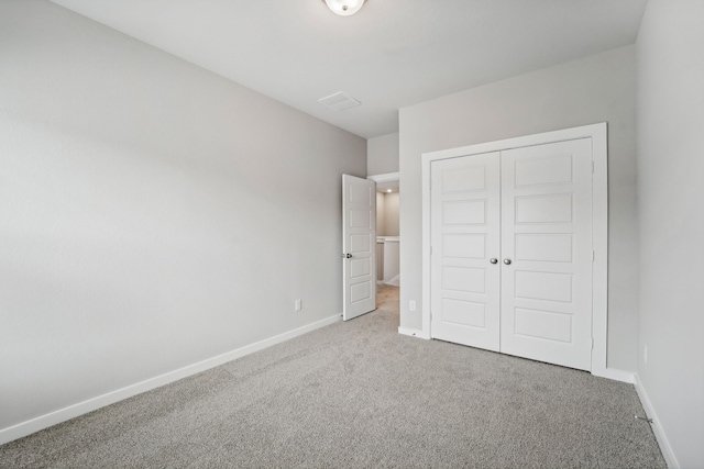 unfurnished bedroom featuring carpet and a closet