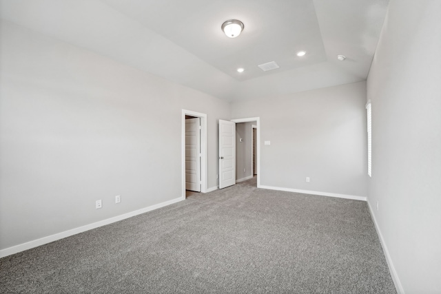 unfurnished bedroom with carpet flooring and lofted ceiling