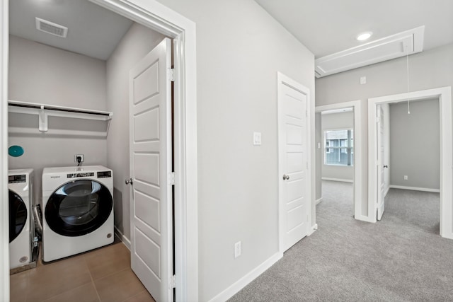 laundry room with light colored carpet and washing machine and clothes dryer