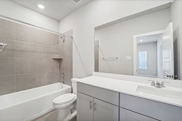 full bathroom featuring vanity, toilet, and tiled shower / bath