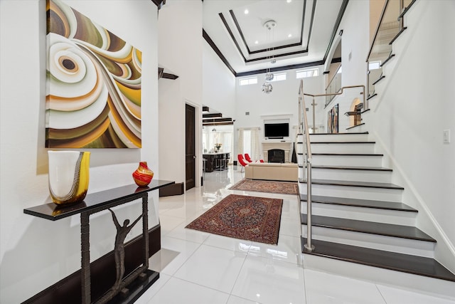 tiled foyer featuring a towering ceiling