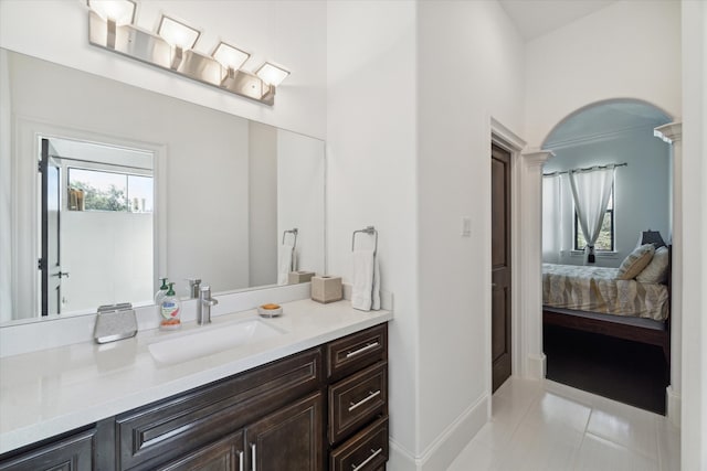 bathroom with vanity, decorative columns, and tile patterned floors