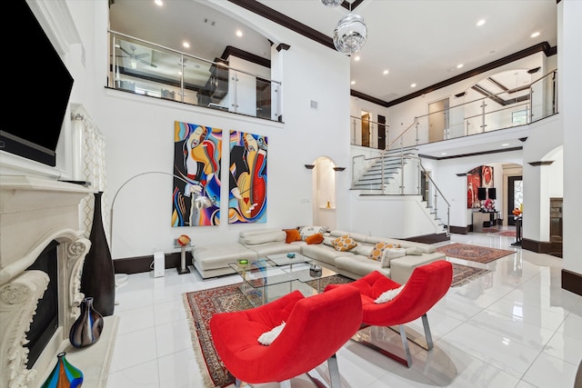 living room featuring light tile patterned flooring, ornamental molding, and a high ceiling