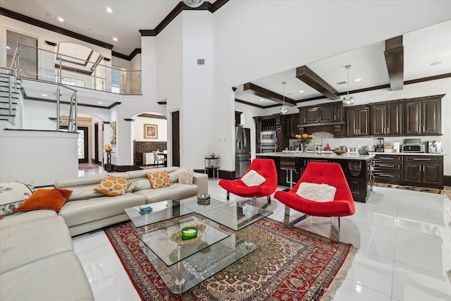 living room with light tile patterned floors and a high ceiling