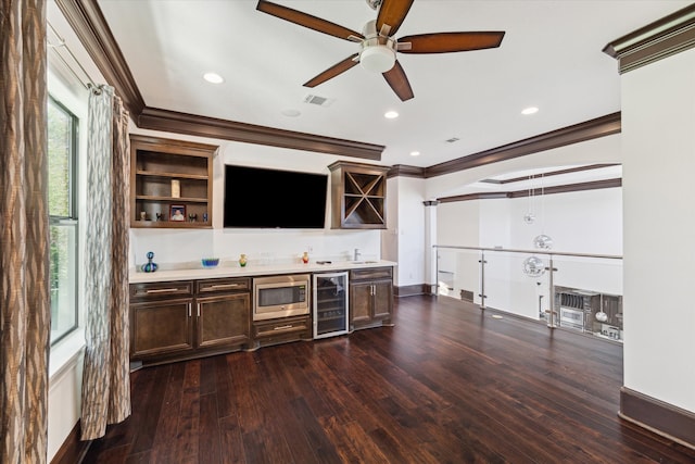 bar with wine cooler, stainless steel microwave, dark hardwood / wood-style flooring, and crown molding