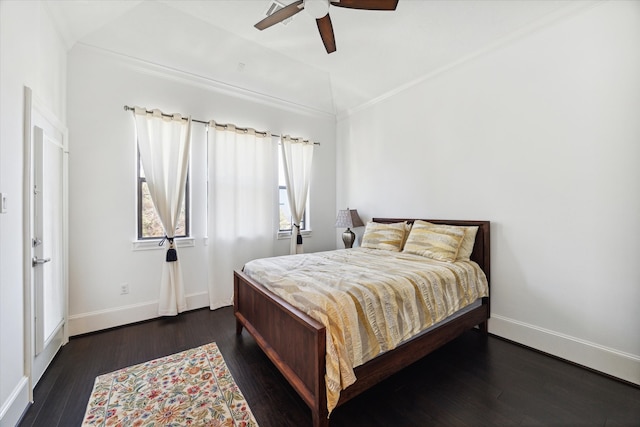 bedroom featuring dark wood-type flooring, crown molding, and ceiling fan