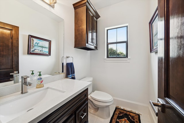 bathroom with vanity, toilet, and tile patterned floors