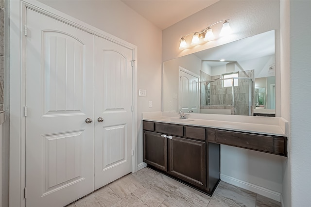 bathroom featuring vanity and a shower with shower door