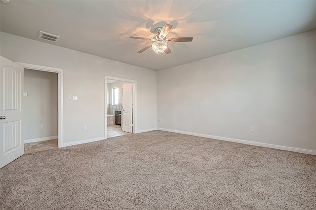 spare room with light carpet and ceiling fan