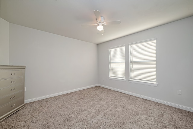 unfurnished room featuring ceiling fan and carpet floors