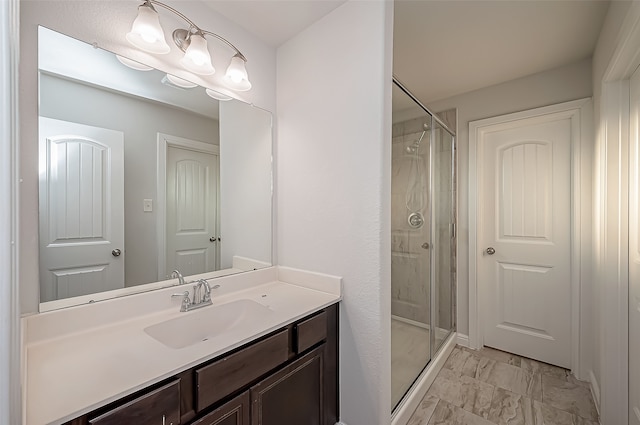 bathroom with vanity and a shower with shower door