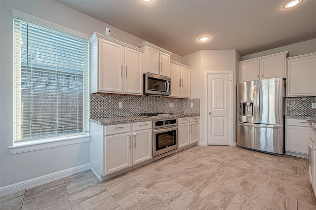 kitchen featuring white cabinets, stainless steel appliances, and plenty of natural light