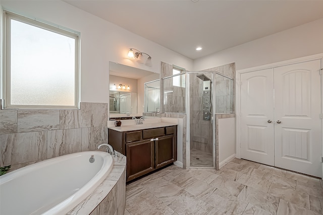 bathroom featuring independent shower and bath and vanity