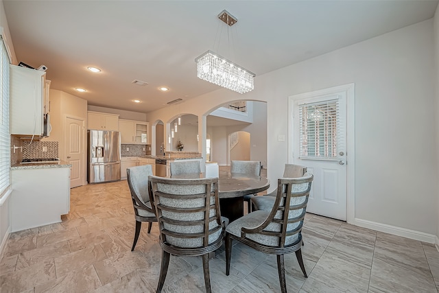 dining room featuring a chandelier and sink