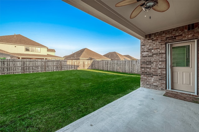 view of yard with ceiling fan and a patio area