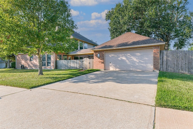 view of front of house featuring a garage and a front lawn