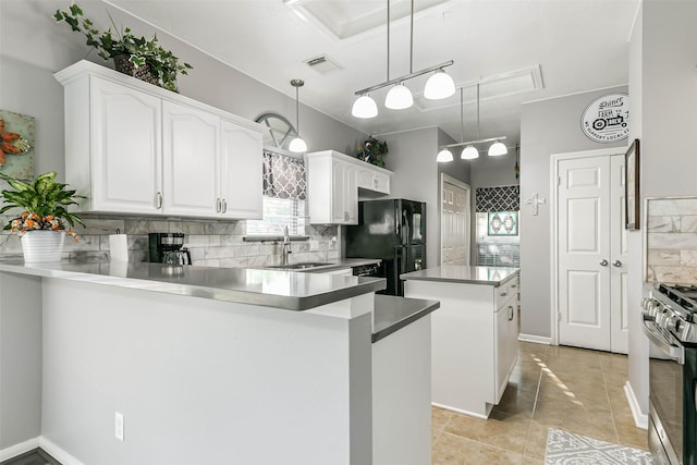 kitchen featuring a center island, white cabinetry, sink, kitchen peninsula, and gas stove