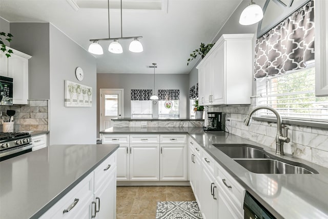 kitchen with sink, white cabinetry, decorative backsplash, and pendant lighting