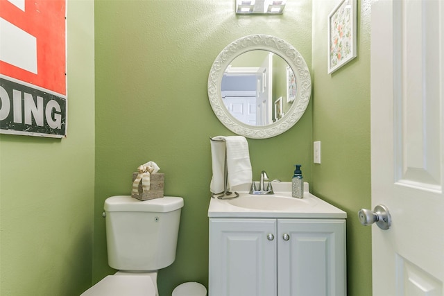 bathroom with toilet and vanity