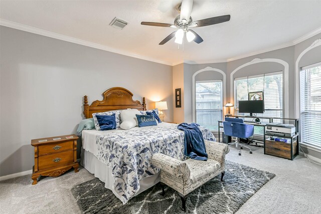 carpeted bedroom featuring ceiling fan and crown molding