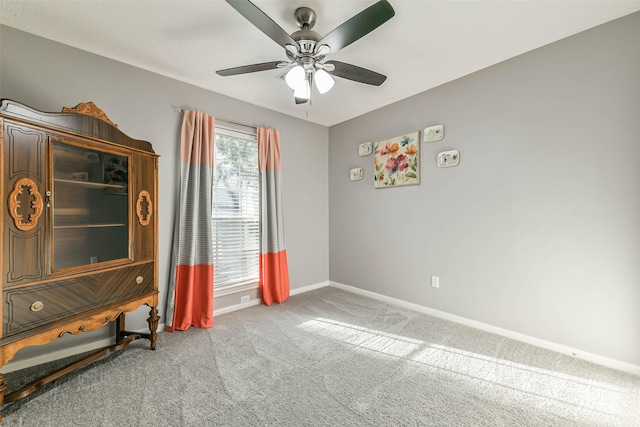 interior space with ceiling fan and carpet flooring