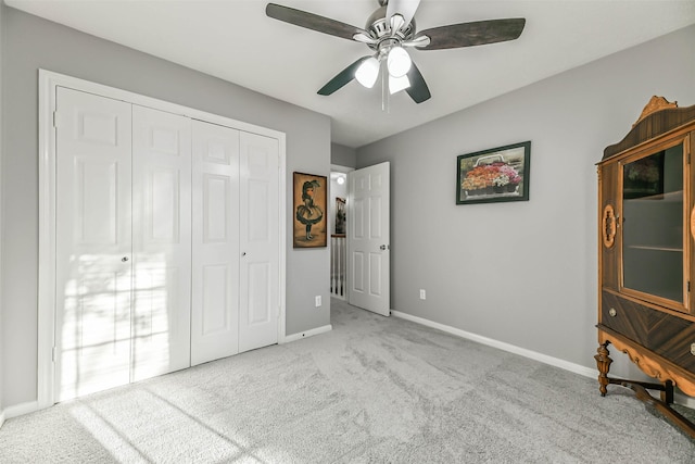 unfurnished bedroom with a closet, ceiling fan, and light carpet