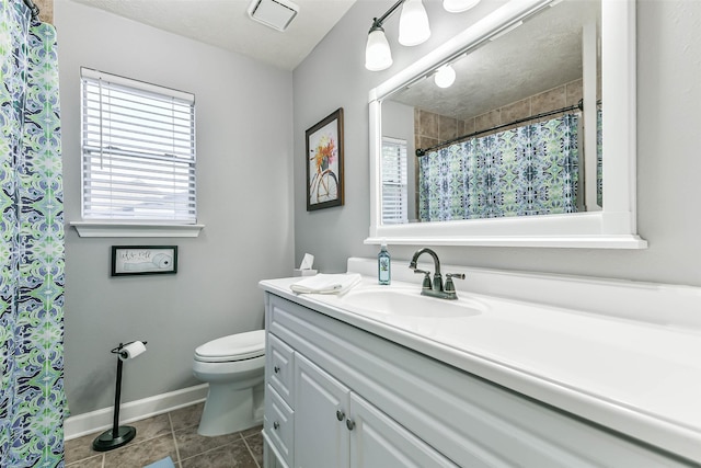 bathroom featuring toilet, tile patterned flooring, and vanity