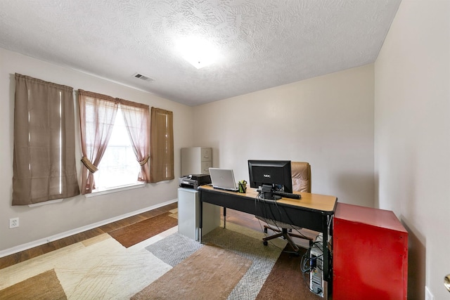 office space featuring dark wood-type flooring and a textured ceiling