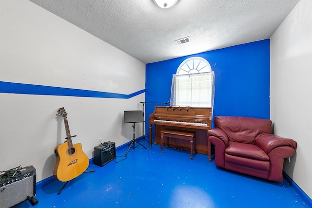 1410 Hovas Ln, Brookshire, TX 77423 - living area featuring concrete floors, a textured ceiling, visible vents, and baseboards