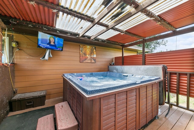 wooden deck featuring a hot tub