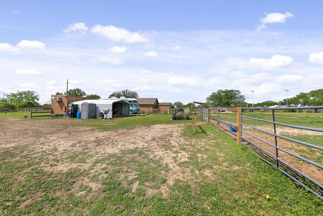 view of yard featuring a rural view and an outdoor structure