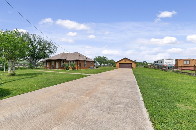 view of front of house with a garage, a front yard, and an outdoor structure