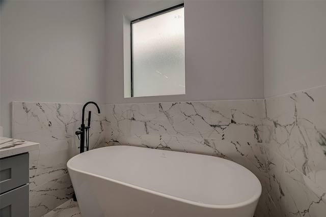 2322 Tuam, Houston, TX 77004 - bathroom with tile walls, a freestanding tub, vanity, a wainscoted wall, and marble finish flooring