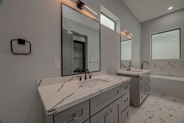 2322 Tuam, Houston, TX 77004 - bathroom with two vanities, a bath, marble finish floors, and recessed lighting